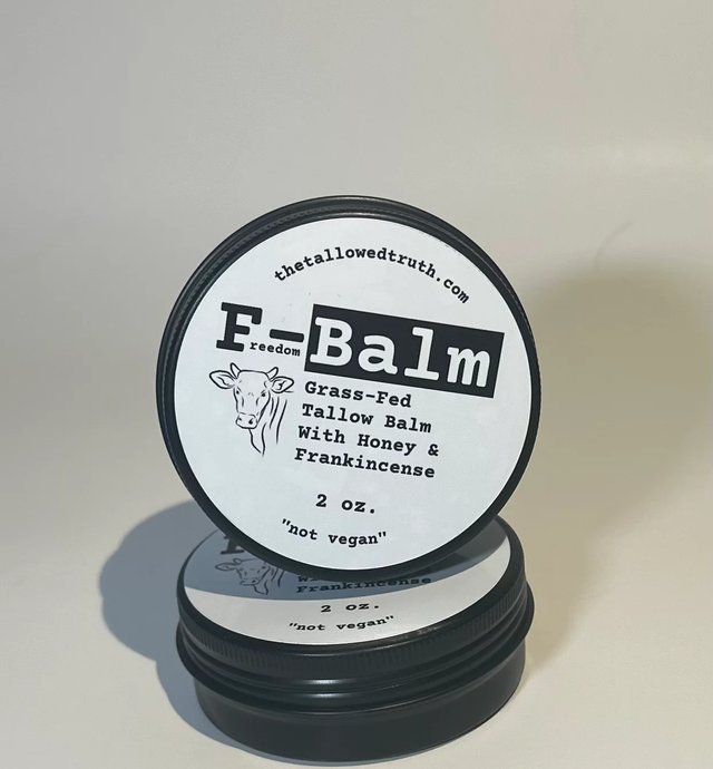 Stacked tins of F-Balm tallow balm