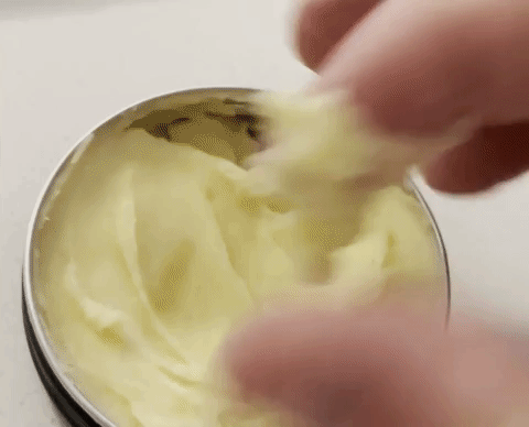 A fingertip scooping whipped tallow balm